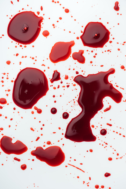 top view of messy blood droplets on white tabletop - Foto, Imagem