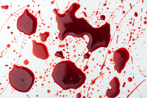 Close-up shot van chaotische bloed druppels op wit - Foto, afbeelding