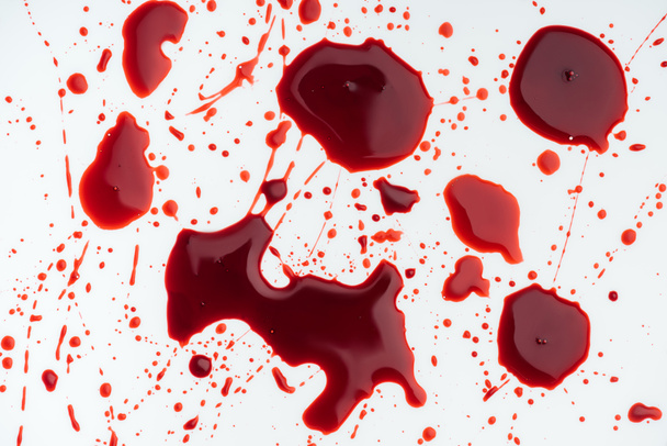 close-up shot of messy blood droplets on white surface - Fotoğraf, Görsel