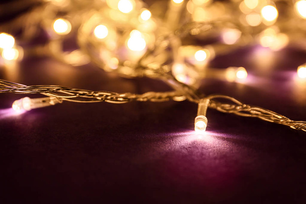 Glowing Christmas lights on dark background - Photo, Image