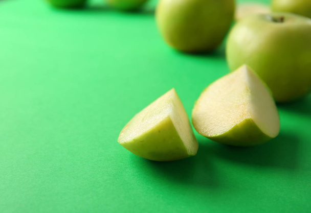 Cut tasty apple on color background - Photo, image