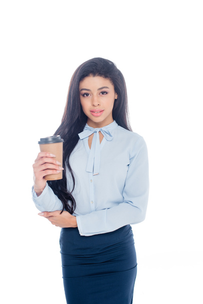 beautiful young african american businesswoman holding coffee to go and looking at camera isolated on white  - Foto, Imagen