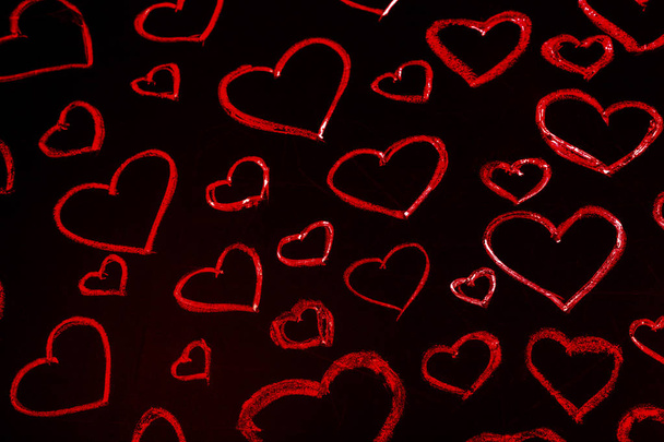 hearts drawn in red chalk on a black board, background image - Photo, Image