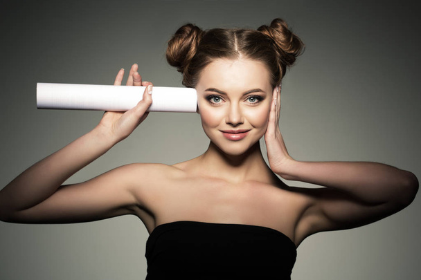 Beautiful girl listens in the paper roll. Woman couting news and gossip.  - Photo, image