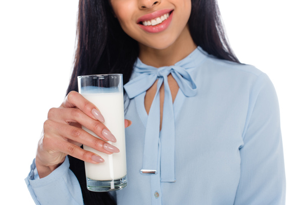 cropped shot of smiling african american girl holding glass of milk isolated on white  - Фото, изображение