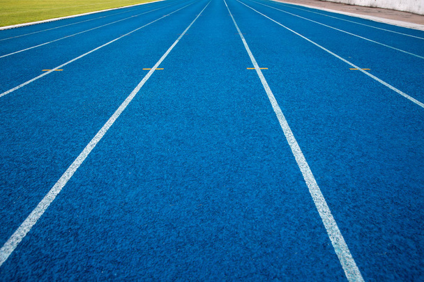 Blue running track in stadium. rubber running tracks in outdoor stadium.  - Foto, Imagen
