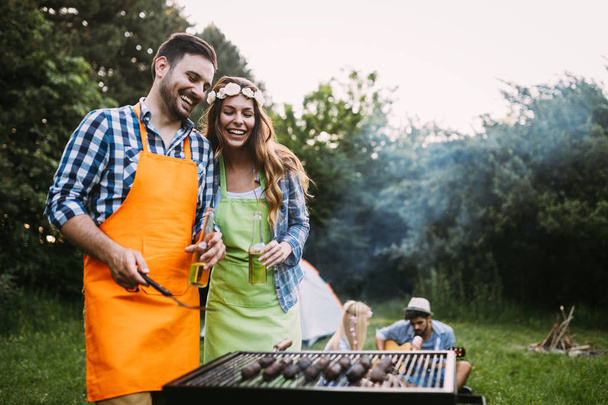 woman and handsome man having barbecue - Fotografie, Obrázek