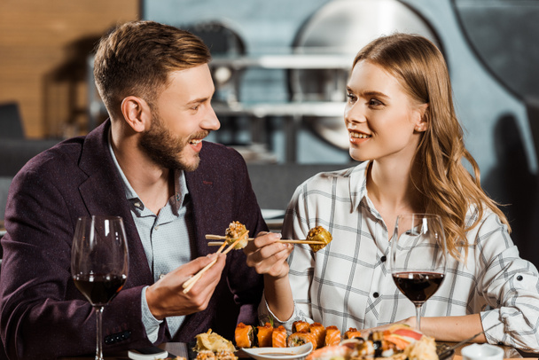 Attractive young adult couple having dinner in restaurant - Photo, Image