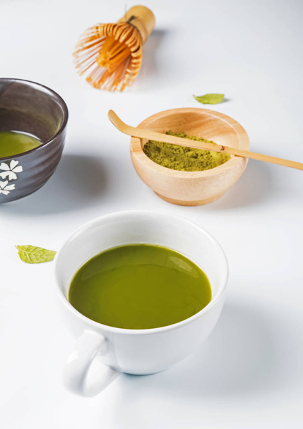 Green matcha tea in the cup on the white background - Foto, Bild