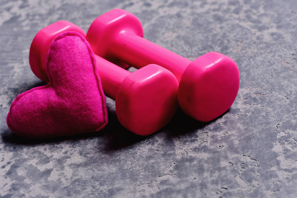 Shaping and fitness equipment. Dumbbells made of pink plastic - Φωτογραφία, εικόνα