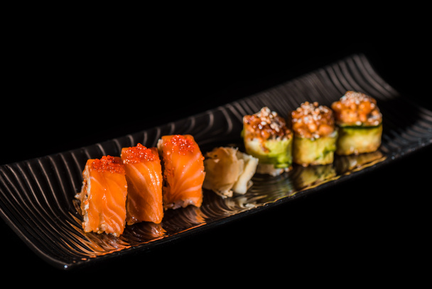 Set of  tasty sushi rolls isolated on black - Photo, Image