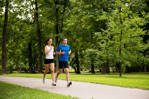 Jogging together - young couple running - Foto, immagini
