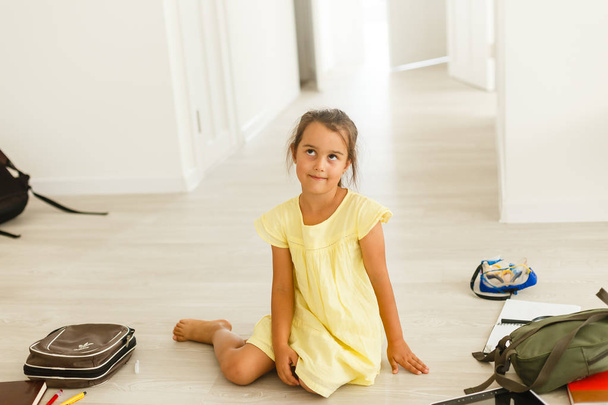 cute little girl in yellow dress sitting on the floor - Φωτογραφία, εικόνα