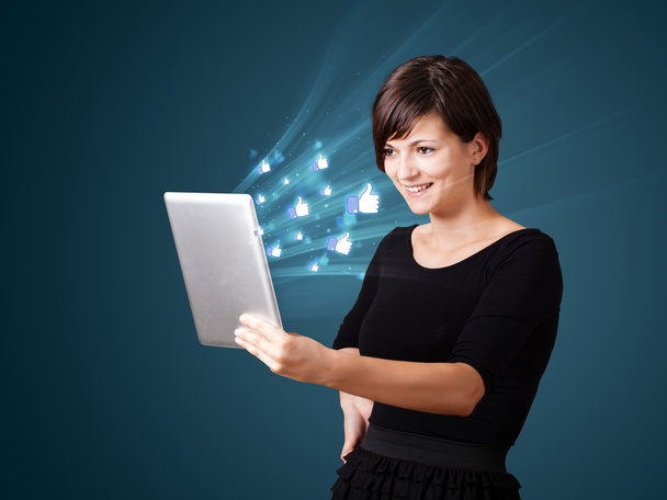 Young woman looking at modern tablet with abstract lights and so - Foto, immagini