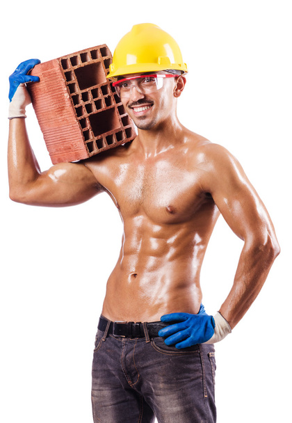 Muscular builder with bricks on white - Фото, зображення