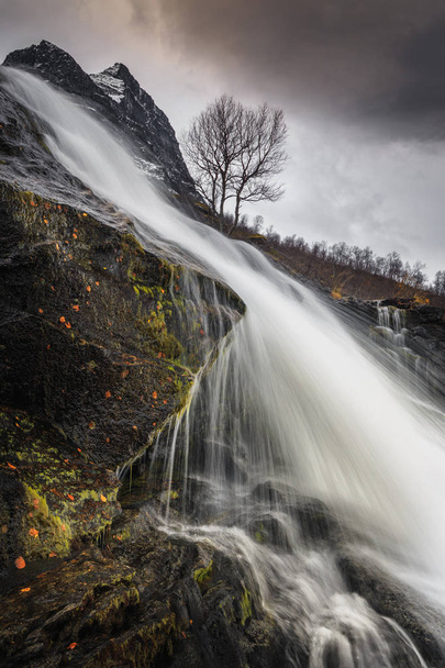 Zobacz na wodospad na rzece Fluo, spada w dół do doliny Innerdalen, góry Trollheimen, norweski park narodowy. - Zdjęcie, obraz