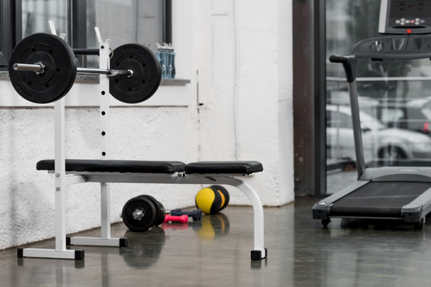 treadmill, barbell and weights in modern gym - Photo, Image