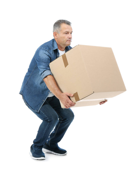 Full length portrait of mature man lifting carton box on white background. Posture concept - Foto, afbeelding