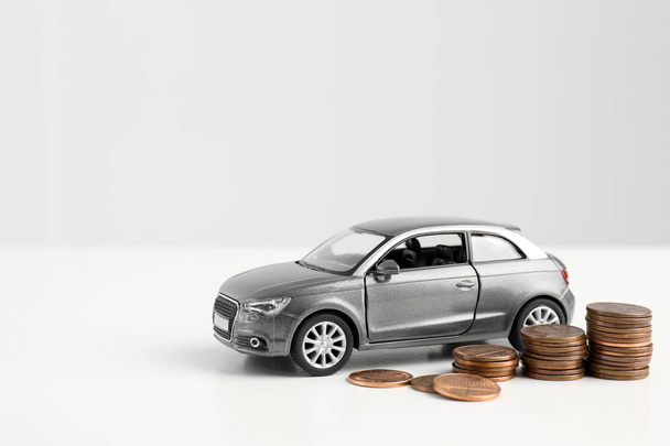 Toy car and money on white background, space for text. Vehicle insurance - 写真・画像