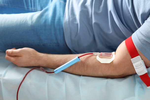 Man donating blood to save someone's life in hospital - Zdjęcie, obraz