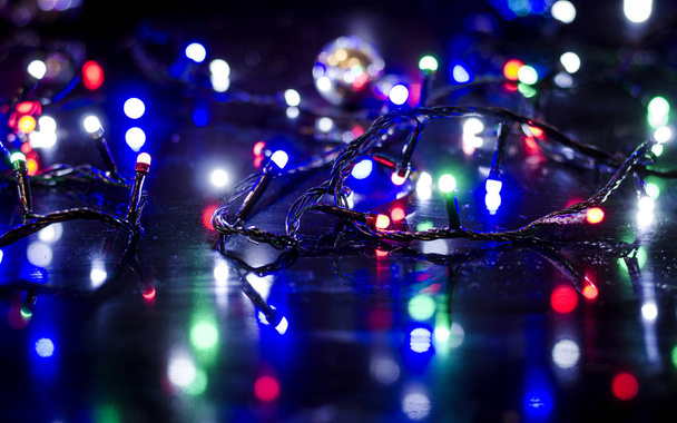 Christmas background, garland lights, holiday toys in blue - Photo, Image