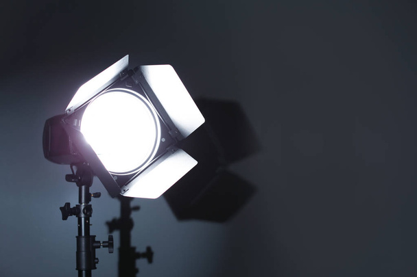 Profesjonalne zdjęcie studio sprzęt oświetleniowy na ciemnym tle. Miejsca na tekst - Zdjęcie, obraz
