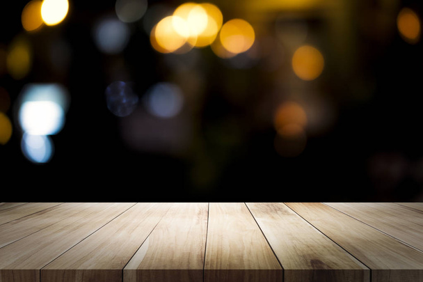 Empty wooden table for present product on bokeh at night blur background with bokeh image - Photo, Image