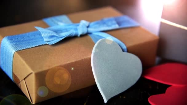 gift boxes with paper hearts on wood table close up - Video, Çekim