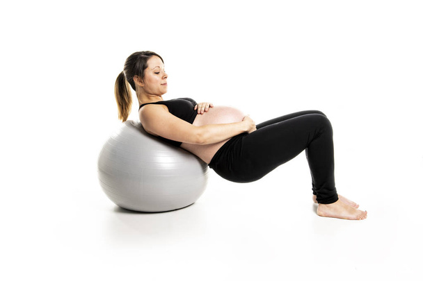 A Sporty pregnant woman exercising with ball - Photo, Image