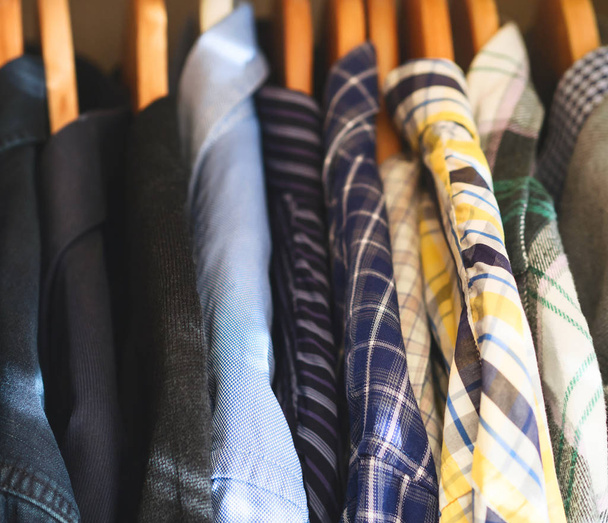 Mans closet hangers shirts closeup - Фото, изображение