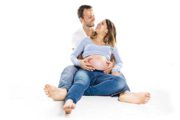 A Pregnant woman with man on studio isolated on white - Fotografie, Obrázek