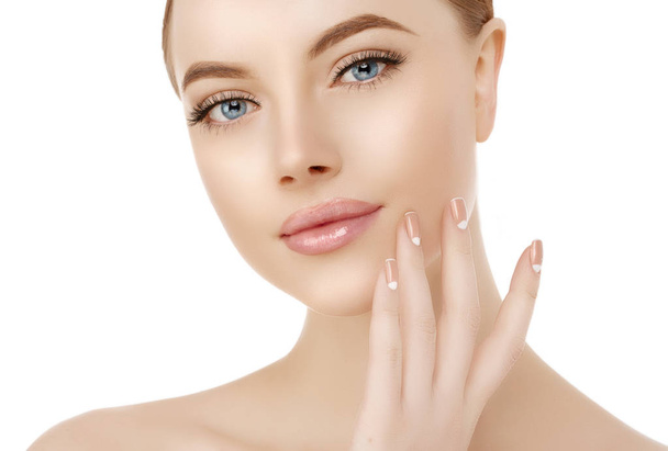 Beautiful woman face close up studio on white. Beauty spa model female with clean fresh skin closeup, with perfect skin. Youth fresh skin care concept. Portrait of girl looking at camera, smiling. Cosmetology, manicure nails on hands - Photo, image