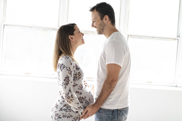 A Handsome man and beautiful pregnant wifes tummy - Valokuva, kuva