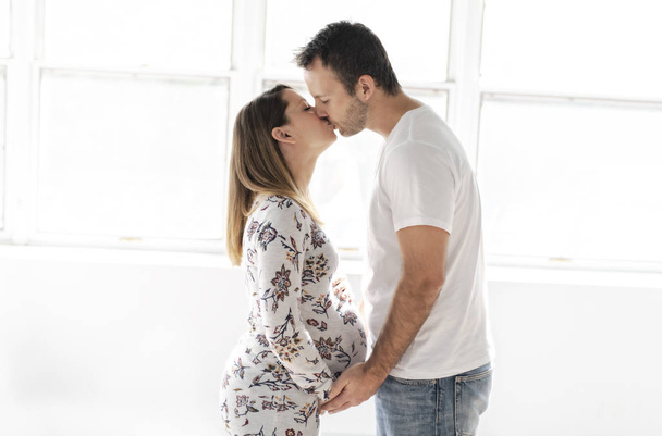 A Handsome man and beautiful pregnant wifes tummy - Foto, immagini