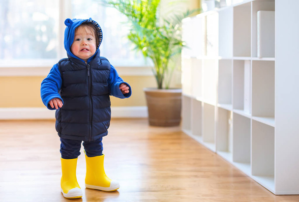 Toddler boy bundled up in winter clothes - Fotó, kép