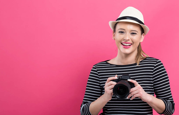 Young woman with a professional camera - Foto, imagen