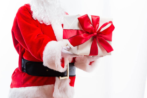 Santa holding a Christmas gift - Zdjęcie, obraz