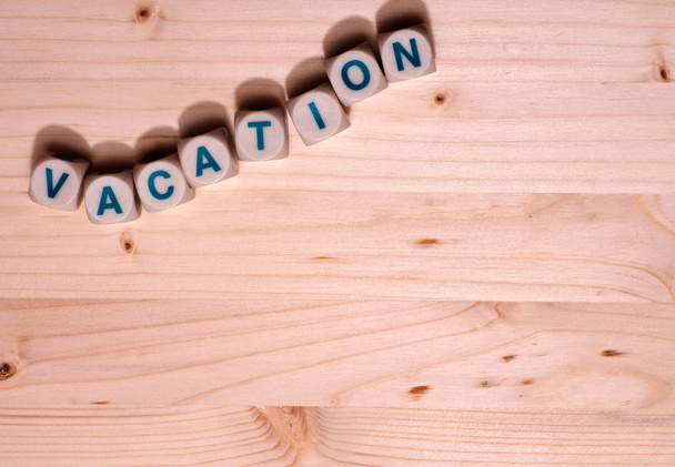 Blank light colored wood fills this template image with the word Vacation spelled out in blocks along the top.  - Photo, Image