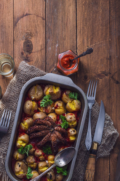 Baked octopus with potatoes, top view, copy space - Fotografie, Obrázek