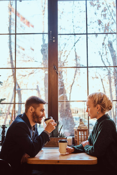 Romantic couple in the cafe is drinking coffee and talking.  - Photo, Image