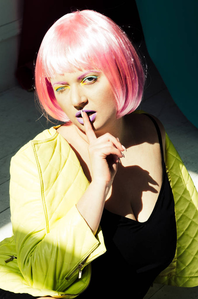 portrait of young sensual woman with pink hair in black dress - 写真・画像