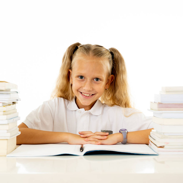 Happy beautiful cute with blond hair little schoolgirl likes studying and reading books in creative education concept with Back to school theme isolated on white background. - Photo, Image