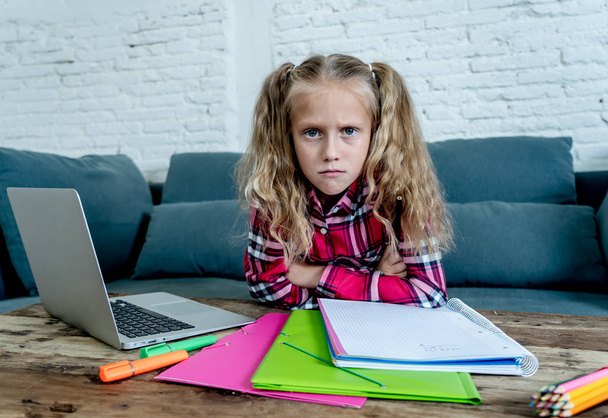 Beautiful cute blonde 9 years elementary student feeling sad bored and a overwhelmed trying to study at home in learning difficulties exams homework and school education concept. - Fotoğraf, Görsel
