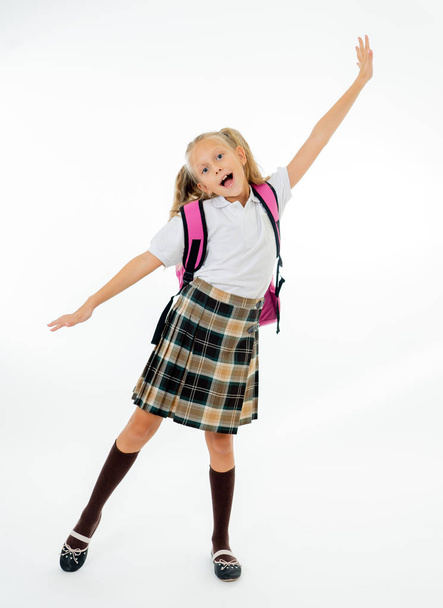 Adorable beautiful little schoolgirl with big pink schoolbag feeling excited and happy being back to school isolated on white background in end of the year and children education concept. - 写真・画像