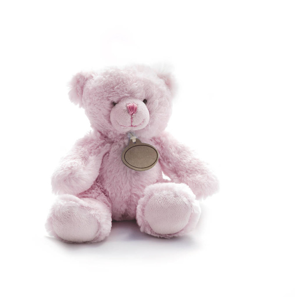 Kleine roze Teddy Bear speelgoed op witte achtergrond - Foto, afbeelding