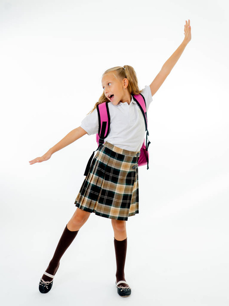 Adorable beautiful little schoolgirl with big pink schoolbag feeling excited and happy being back to school isolated on white background in end of the year and children education concept. - Valokuva, kuva