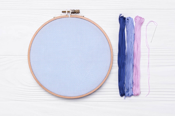 Tools for cross stitch. Threads, a hoop for embroidery, canvas and needle - Photo, Image
