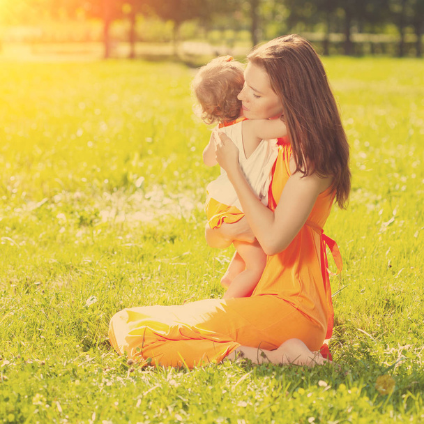 Beautiful Mom and baby outdoors. Happy family playing in nature. Mom and baby. Mother and child - Foto, immagini