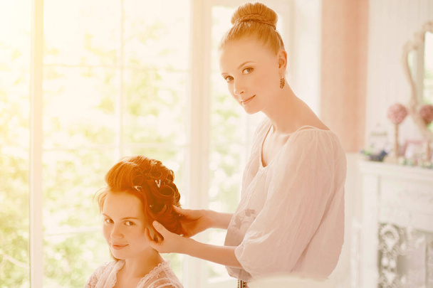 Hair stylist makes the bride before the wedding - Photo, image