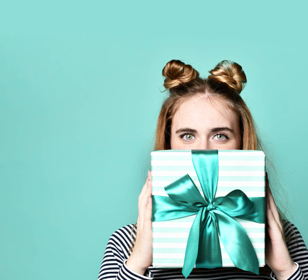 Portrait of a happy young woman hide under blue present gift box - Foto, Imagen